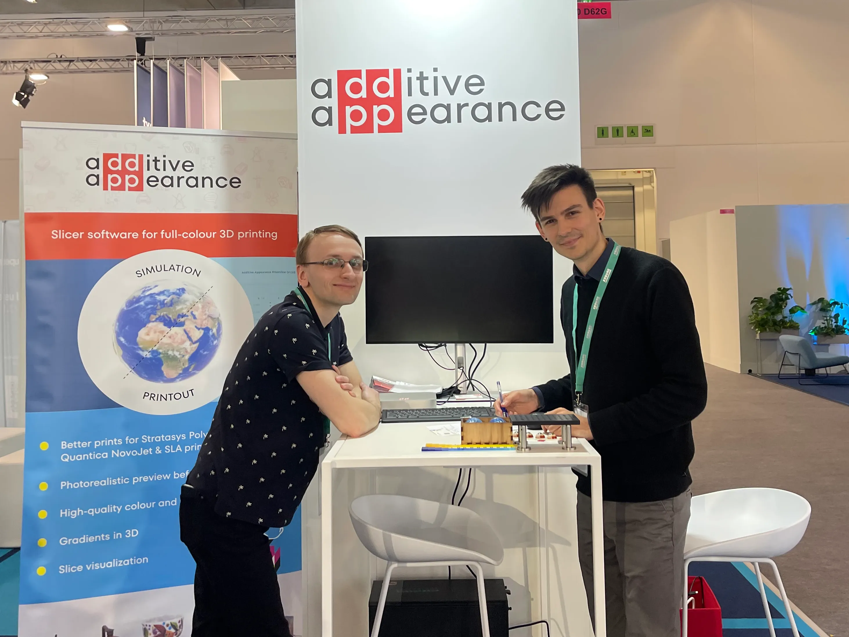 Vojtěch Tázlar and Tobias Rittig standing at the Additive Appearance booth in the startup corner on Formnext 2024.