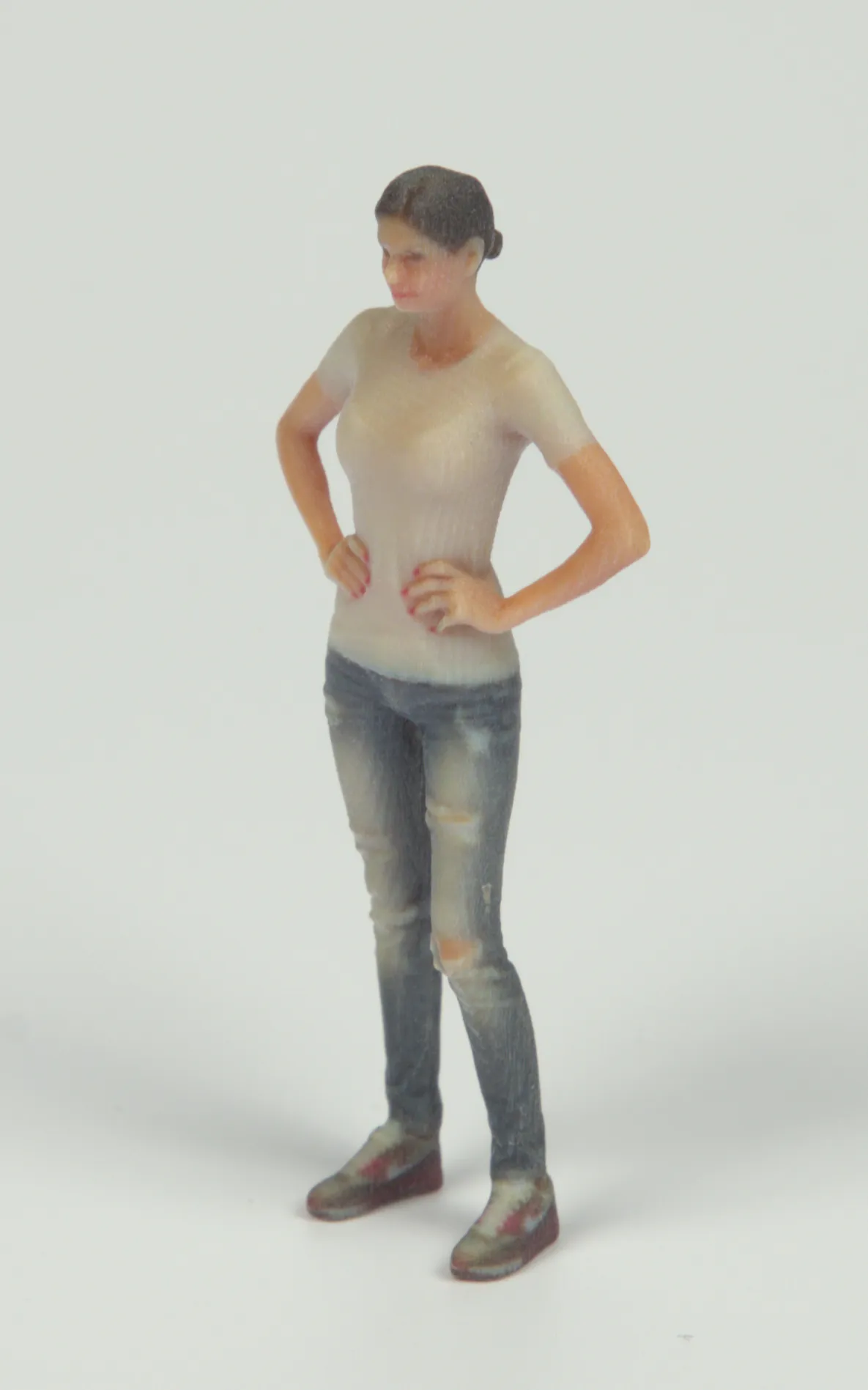 Two female figurines, that were full-color 3D printed, lit by an indoor environment and diffuse light from the front.