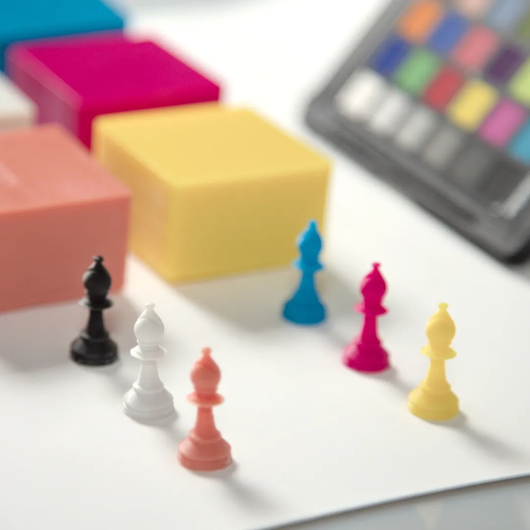 Six SLA 3D printed chess figurines in multiple colors.